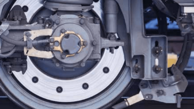 Close-up of a railway axlebox and suspension system, showcasing intricate mechanical components used for predictive maintenance and digital tracking