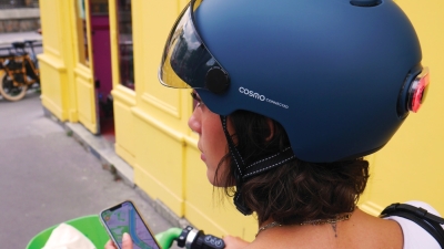 Cosmo Connected smart helmet with rear light near Eiffel Tower — showcasing innovative urban mobility gear enabled by GS1 GTINs and digital product data